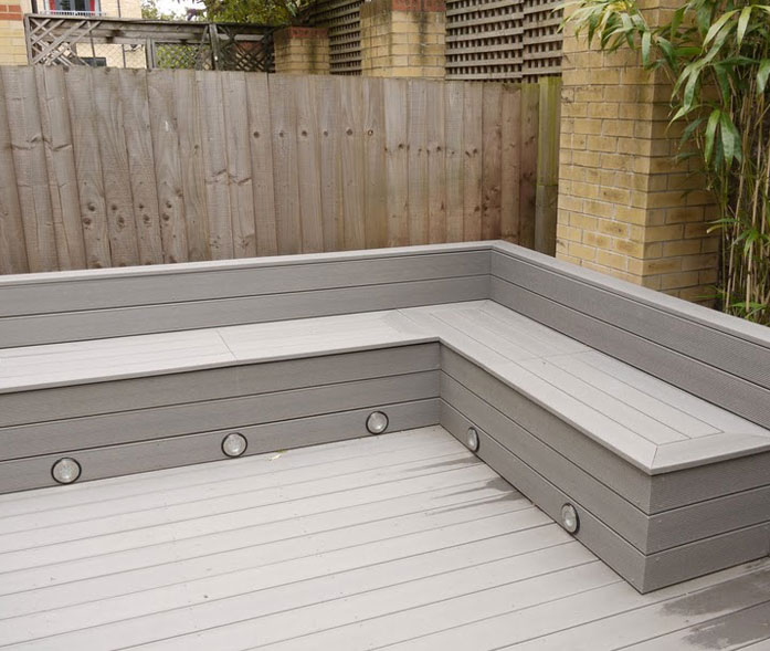'EcoDeck Pebble Grey' composite decking with seating/storage and lighting.